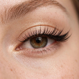 Wing false lashes worn, eye close-up